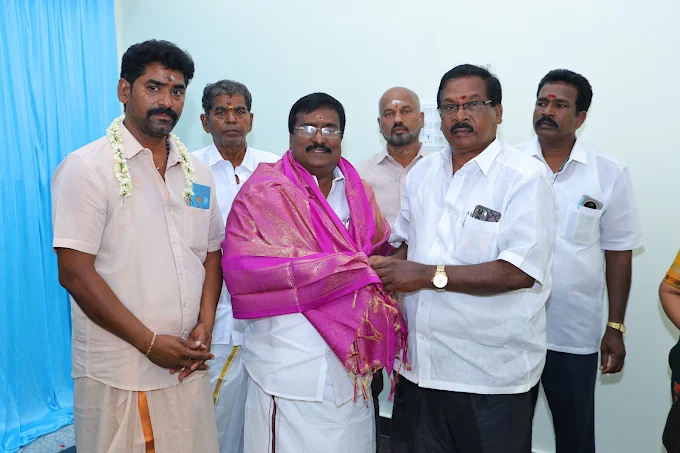 Elders being honoured with a shawl on stage during a family function